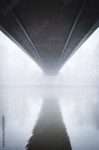 Metal bridge on the Mittellandkanal in Bramsche, Germany, in winter fog — moody canal landscape