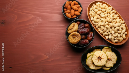 Assorted dried fruits and nuts on wooden surface