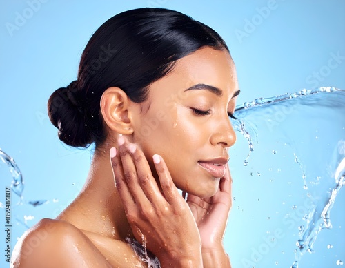A woman's face gently touched by splashing water, evoking a sense of freshness and hydration for healthy skin