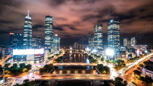 Stunning Night View of a Modern Cityscape with Illuminated Skyscrapers and Busy Roads.