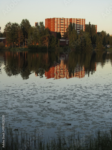 House on the shore of a lake and the reflection on water
