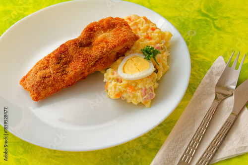 Traditional Czech Christmas fried carp with potato salad on plate