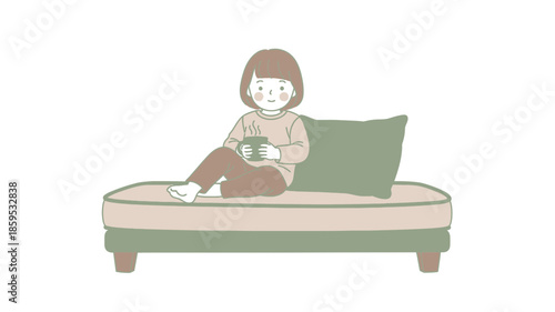 A young girl sitting on a sofa with a cup in her hands.