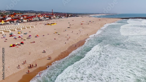 Aerial orbit of Praia da Baia beach in Espinho Portugal on a sunny summer day