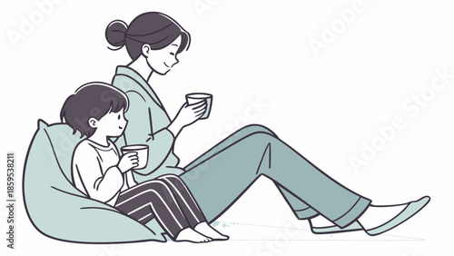 A mother and child are sitting together on a beanbag chair, enjoying a warm beverage.