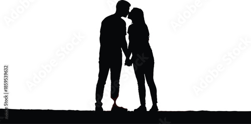 Silhouette of a couple kissing while holding hands against a vibrant orange and purple sunset sky