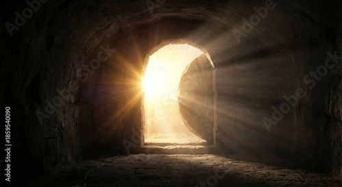 Resurrection of Jesus Christ concept with empty tomb stone rolled away and bright light beams from outside