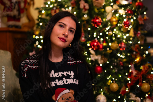 woman in pajamas near the christmas tree