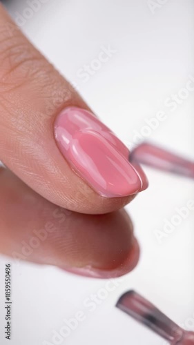 Wallpaper Mural woman is applying pink nail polish to her fingernails with brush, reflected in glossy surface, creating calm, professional mood, beauty, self-care, elegance, and skincare., joy, serenity, wellness Torontodigital.ca