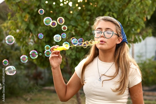 girl blowing bubbles