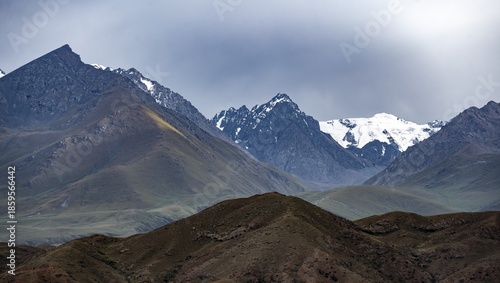 Twilight over snow-covered mountain peaks and steep slopes, Kyrgyzstan