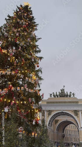 St. Petersburg. Vertical video of beautifully decorated Christmas tree on Palace Square with General Staff Building arch in background during New Year and Christmas holidays on snowy day