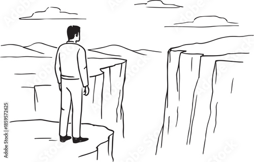 Man standing at cliff edge looking across chasm