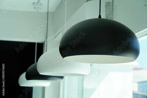 Modern minimalist lighting fixtures hanging from the ceiling in a contemporary interior design setting with a focus on simplicity and elegance