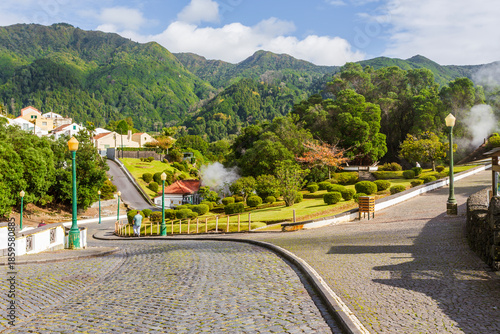 Wide landscape of Caldeiras das Furnas geothermal field with steam vents and boiling mud in São Miguel, Azores.