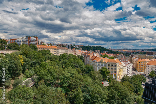 Breathtaking panoramic view of Prague, showcasing its historic city center with iconic buildings, charming red-roofed houses.