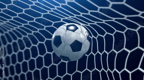 Close-up view of a soccer goal net catching a white-and-black ball under deep blue stadium lights!!!