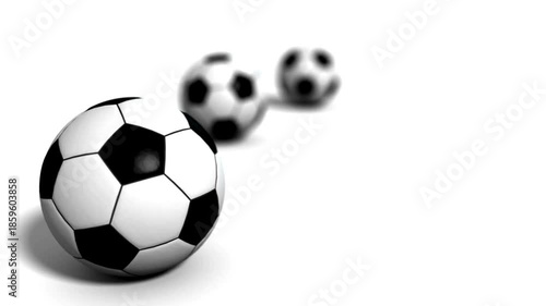 A large foreground soccer ball with black-and-white patches; two smaller balls fading into distance