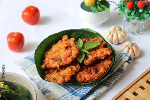 Billede på lærred Bakwan jagung, a beloved Indonesian fritter, is made from sweet corn mashed with aromatic spices, topped with shrimp, then deep-fried to golden crispness