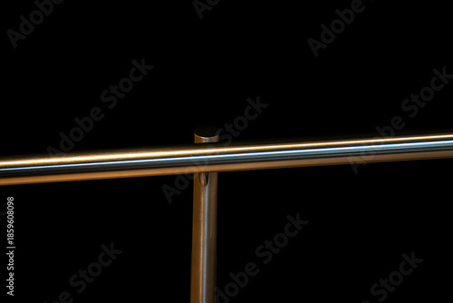 Brass railing against black background