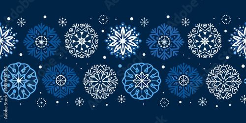 Seamless pattern of intricate white and blue snowflakes on a dark background
