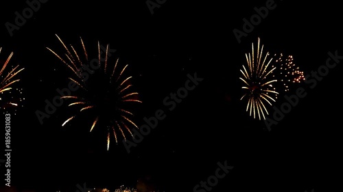 4K. loop seamless of real fireworks background golden shining fireworks with bokeh lights in the night sky. glowing fireworks show. New year's eve fireworks celebration multiple colors 