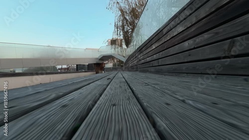 Wallpaper Mural City park. Flyover above the wooden surface of street benches. Architecture and environment. Low angle shot. Atmospheric B-roll footage Torontodigital.ca