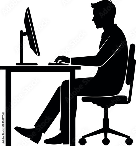 Silhouette of a man sitting at a desk working on a computer