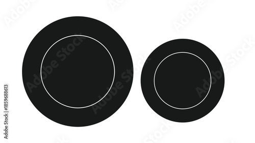 Two black circles with white outlines and smaller inner circles shown