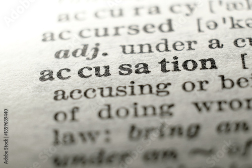 Close-up of “accusation” on a dictionary page, concept for blame, dispute, investigation and justice.