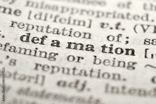 Defamation definition in dictionary, macro close-up