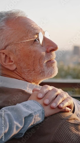 Woman puts hands on shoulders of disabled senior father
