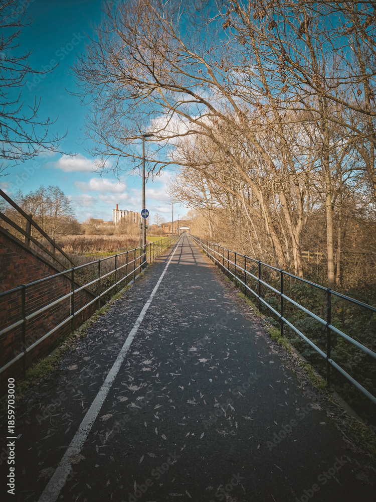 Fototapeta premium Empty pedestrian and cycle path with strong perspective on a sunny day