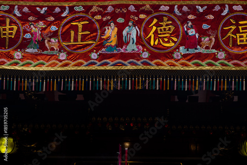 Traditional Chinese Temple Banner With Gold Characters and Mythological Figures