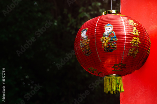 Red Chinese Lantern Hanging On Temple Pillar With Traditional Artwork