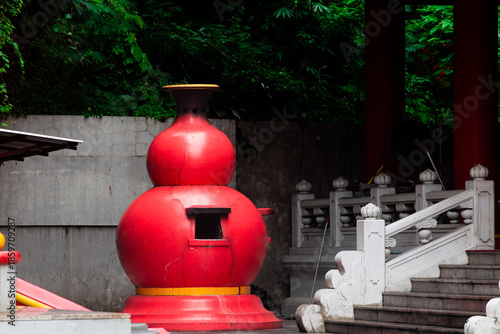Traditional Red Paper Burning Furnace at Chinese Temple Courtyard with Stone Stairs