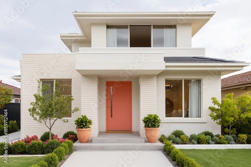 Wallpaper Mural Contemporary home featuring white and beige exterior with paprika-colored door, surrounded by lush greenery and vibrant landscaping, showcasing modern architectural design and inviting atmosphere Torontodigital.ca