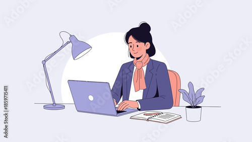 Professional woman working on a laptop at her office desk with a plant and notebook for