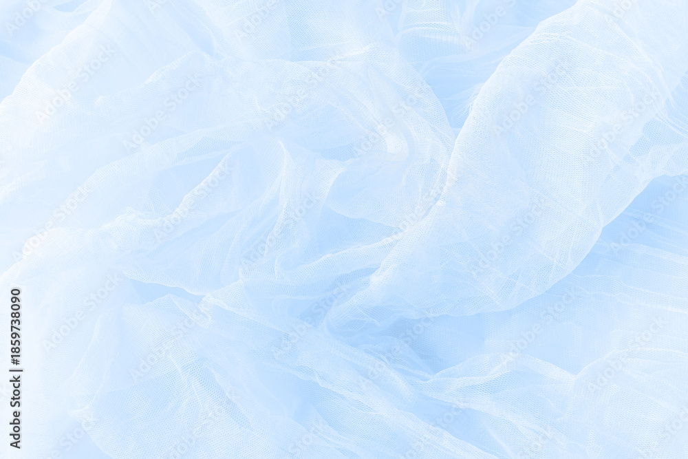 Obraz premium Soft drapery light blue tulle fabric texture background.