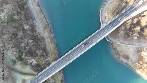 Foto Aerial view from a top-down drone of a bridge with a car over the Rhône River, Massignieu de Rives, France