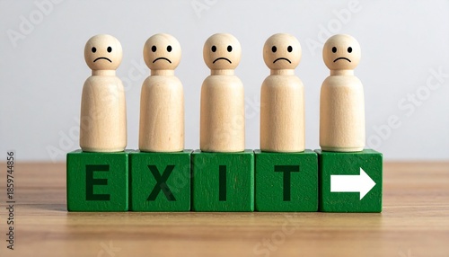 Row of Sad Wooden Peg People Standing on Green Blocks Spelling EXIT with Directional Arrow on a Wooden Surface