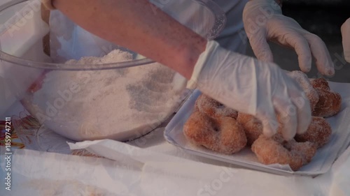 Woman arranging traditional Neapolitan zeppole on dessert tray
