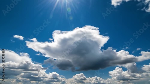 Bright blue sky with fluffy white clouds and sunlight for nature backgrounds