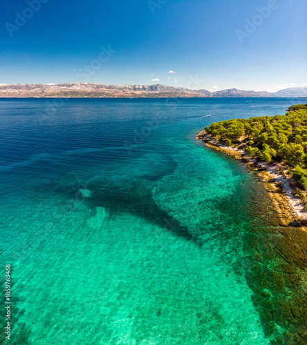Croatia's beautiful Adriatic coast on the island of Brac. Azure sea, pine forests, and beach.