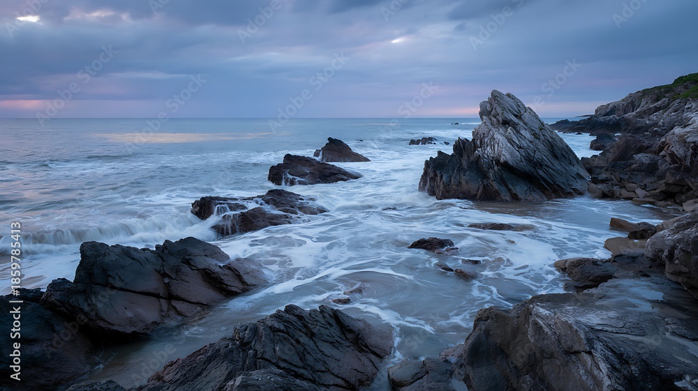 Obraz premium Rugged Rocky Coastline with Crashing Waves Under a Dramatic Cloudy Sky