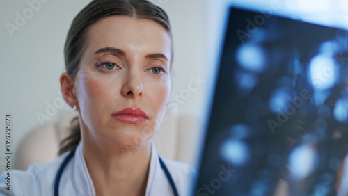 Healthcare provider reading x-ray scan at medical examination clinic closeup