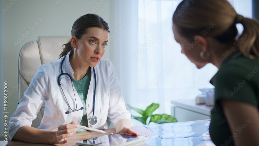 © stockbusters - Hospital physician explaining tablet to woman patient at medicare visit closeup