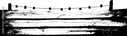 Distressed plywood fence silhouette with clothesline in black and white stencil illustration