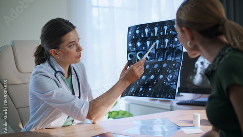 Healthcare worker analyzing x-ray. Closeup happy woman doctor communicating
