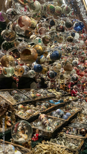 A close-up of a display case with Christmas tree decorations at a Christmas market